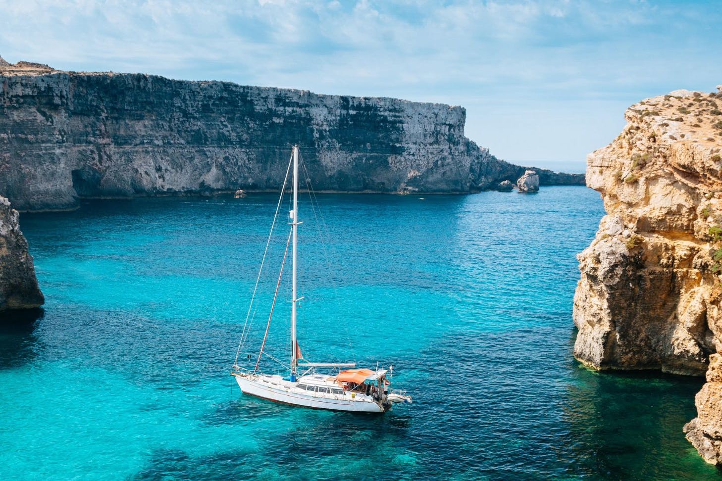 A boat floating on deep blue water in the sunshine